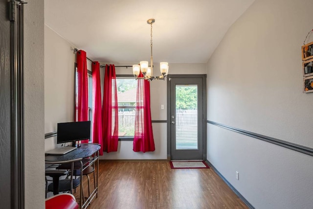 404 Paige Bnd, Hutto, TX 78634 - home office featuring wood finished floors, a chandelier, and vaulted ceiling