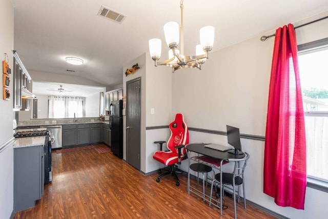 404 Paige Bnd, Hutto, TX 78634 - kitchen featuring appliances with stainless steel finishes, gray cabinetry, a chandelier, dark wood finished floors, and vaulted ceiling