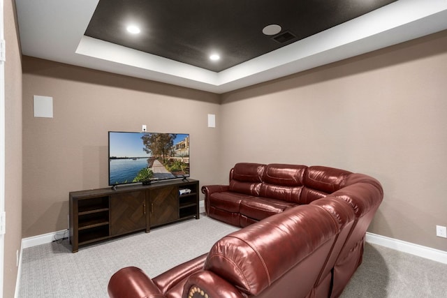 carpeted living room featuring baseboards, a tray ceiling, and recessed lighting
