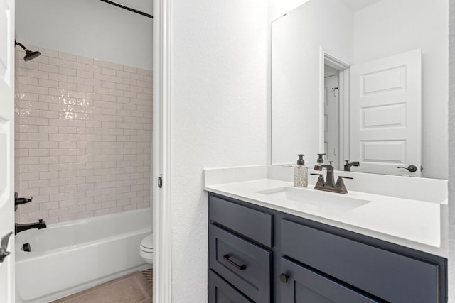 full bath featuring toilet,  shower combination, vanity, and tile patterned floors