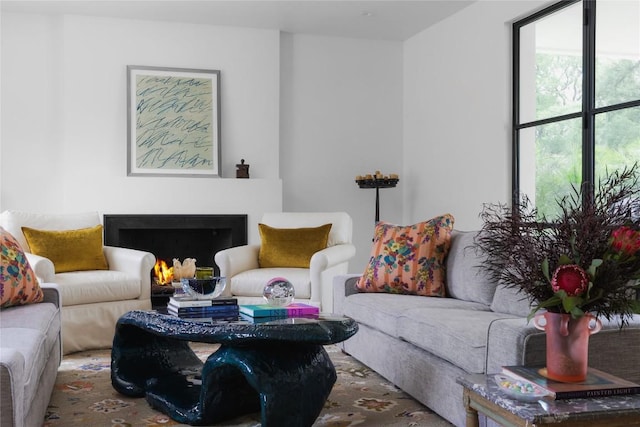 living area featuring a lit fireplace