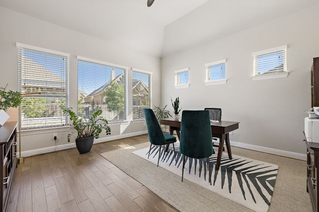 19312 Abigail Way, Pflugerville, TX 78660 - dining area featuring baseboards, healthy amount of natural light, vaulted ceiling, and wood finished floors