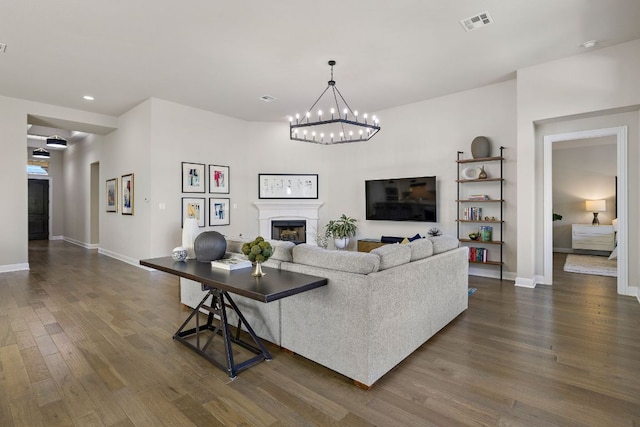 19312 Abigail Way, Pflugerville, TX 78660 - living room with dark wood finished floors, baseboards, a chandelier, a fireplace, and recessed lighting