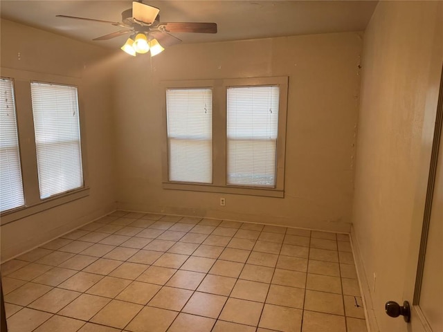 1711 Singleton Ave, Austin, TX 78702 - empty room with light tile patterned floors, ceiling fan, and baseboards
