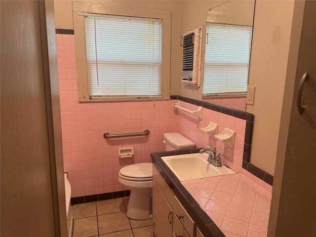 1711 Singleton Ave, Austin, TX 78702 - bathroom featuring tile patterned flooring, toilet, tile walls, and vanity