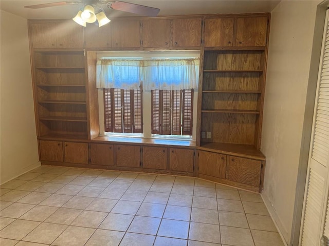 1711 Singleton Ave, Austin, TX 78702 - unfurnished room with ceiling fan, light tile patterned floors, and built in shelves