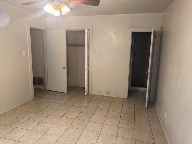 1711 Singleton Ave, Austin, TX 78702 - unfurnished bedroom with a closet, light tile patterned flooring, ceiling fan, and baseboards