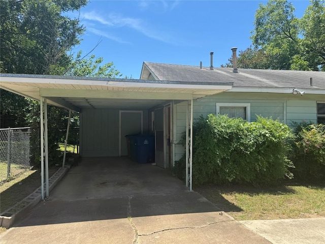 1711 Singleton Ave, Austin, TX 78702 - view of vehicle parking featuring fence, concrete driveway, and an attached carport