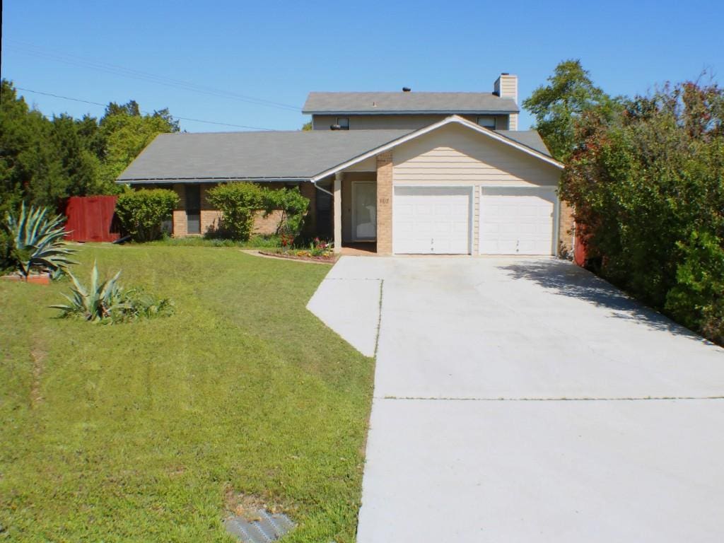 6812 Smokey Hill Rd, Austin, TX 78736 - view of front of house featuring an attached garage, driveway, and a chimney