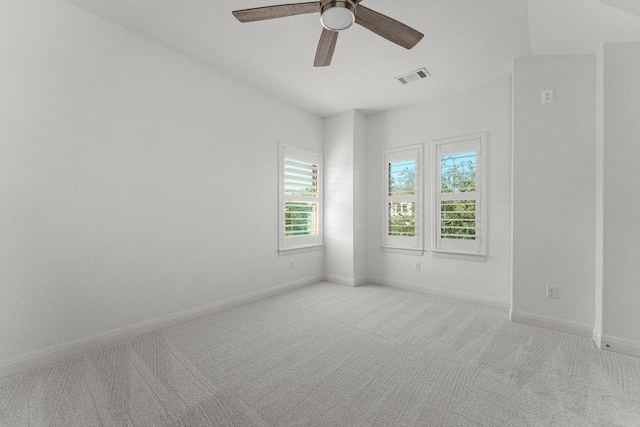 empty room featuring carpet flooring, a ceiling fan, and baseboards