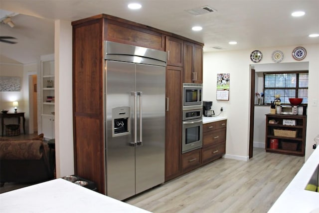 3616 Arrowhead Cir, Round Rock, TX 78681 - kitchen featuring built in appliances, light wood-type flooring, light countertops, recessed lighting, and baseboards