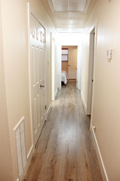 3616 Arrowhead Cir, Round Rock, TX 78681 - corridor with light wood finished floors, attic access, and baseboards