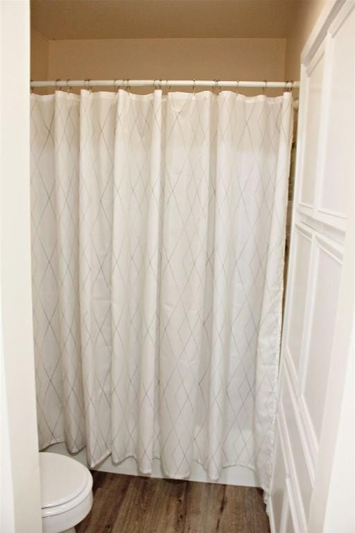 3616 Arrowhead Cir, Round Rock, TX 78681 - full bath with wood finished floors, toilet, and a shower with shower curtain