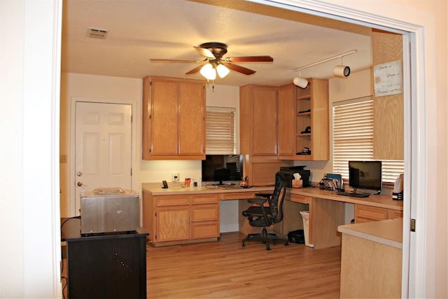 3616 Arrowhead Cir, Round Rock, TX 78681 - home office with a ceiling fan, built in desk, and light wood finished floors
