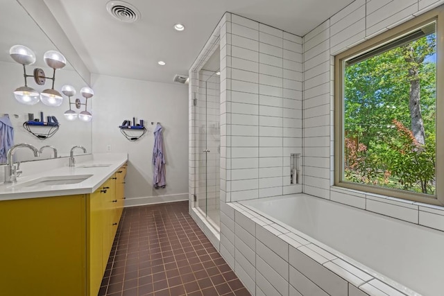 202 Tanglewood Dr, Fredericksburg, TX 78624 - full bath featuring a tile shower, a relaxing tiled tub, double vanity, tile patterned flooring, and baseboards