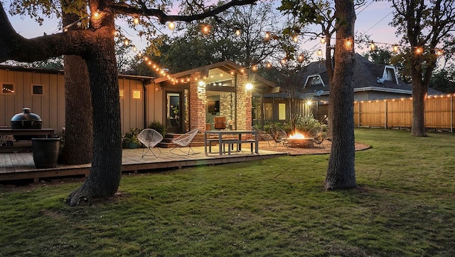 202 Tanglewood Dr, Fredericksburg, TX 78624 - back of house with a fire pit, a wooden deck, and board and batten siding