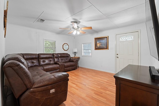 201 N Bowie Ave, Cameron, TX 76520 - living room featuring a ceiling fan, light wood-style floors, and baseboards