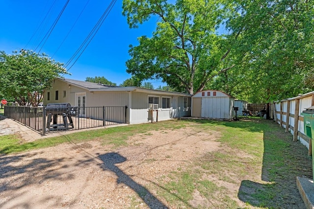 201 N Bowie Ave, Cameron, TX 76520 - fenced backyard with a storage shed, an outdoor structure, french doors, and a patio