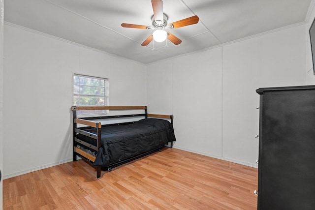 201 N Bowie Ave, Cameron, TX 76520 - bedroom with light wood-style flooring, a ceiling fan, and crown molding