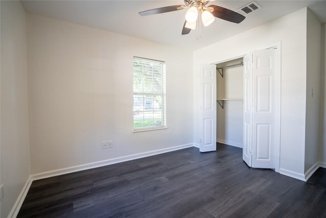 908 Kent St, Taylor, TX 76574 - unfurnished bedroom with dark wood-style flooring, a closet, and a ceiling fan