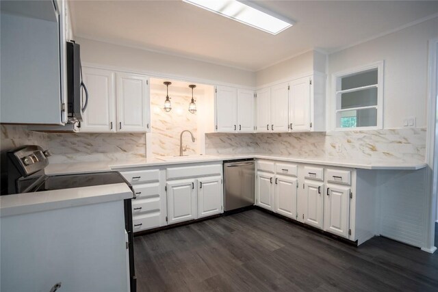 908 Kent St, Taylor, TX 76574 - kitchen with appliances with stainless steel finishes, tasteful backsplash, white cabinets, dark wood-style flooring, and light countertops