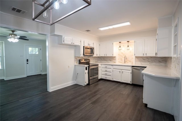 908 Kent St, Taylor, TX 76574 - kitchen with stainless steel appliances, light countertops, backsplash, and white cabinets