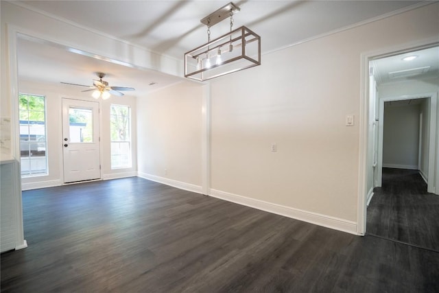 908 Kent St, Taylor, TX 76574 - unfurnished dining area with dark wood finished floors, ornamental molding, and ceiling fan