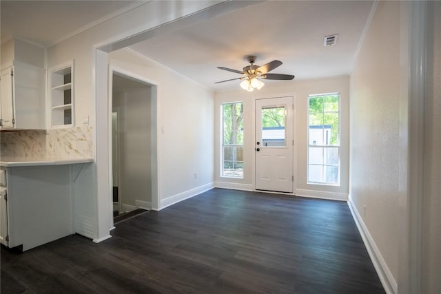908 Kent St, Taylor, TX 76574 - unfurnished dining area featuring ornamental molding, dark wood-style floors, and ceiling fan