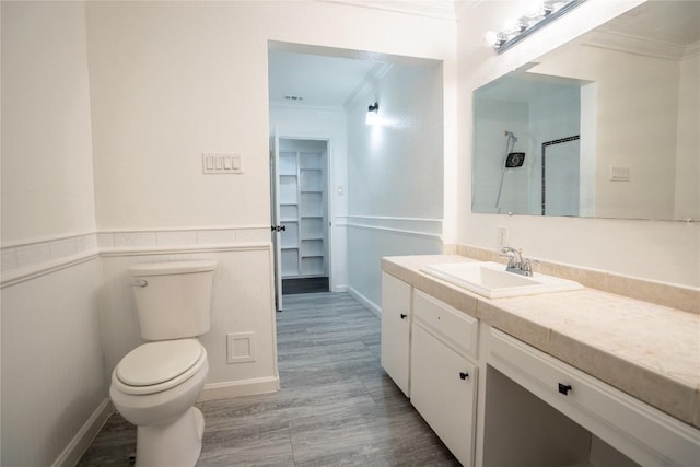 908 Kent St, Taylor, TX 76574 - full bathroom featuring ornamental molding, vanity, wood finished floors, a shower, and wainscoting