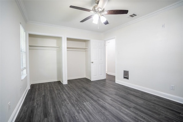 908 Kent St, Taylor, TX 76574 - unfurnished bedroom with dark wood-style floors, multiple closets, ornamental molding, and ceiling fan