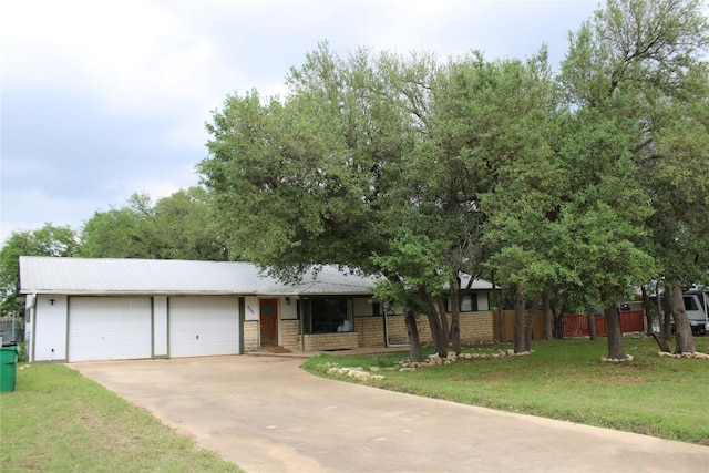 704 Marquis Ln, Cedar Park, TX 78613 - view of front of home with an attached garage, concrete driveway, and a metal roof