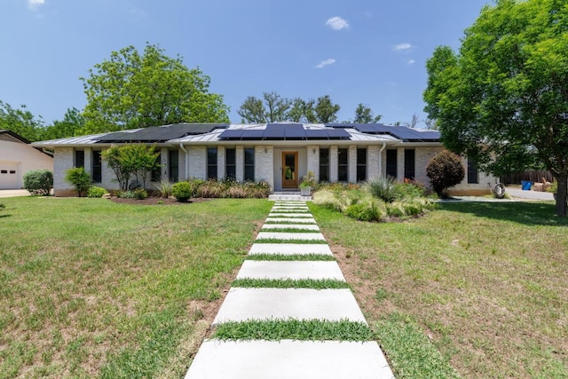 4902 Pony Chase, Austin, TX 78727 - ranch-style house featuring roof mounted solar panels, a front yard, and a standing seam roof