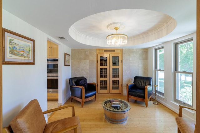 4902 Pony Chase, Austin, TX 78727 - living area with light wood finished floors, a chandelier, and a tray ceiling