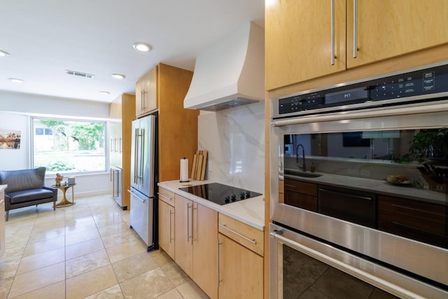 4902 Pony Chase, Austin, TX 78727 - kitchen featuring custom range hood, stainless steel appliances, light tile patterned flooring, light countertops, and recessed lighting