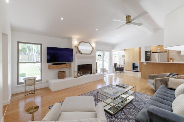 4902 Pony Chase, Austin, TX 78727 - living room with a fireplace with raised hearth, beverage cooler, a ceiling fan, light wood-style flooring, and recessed lighting