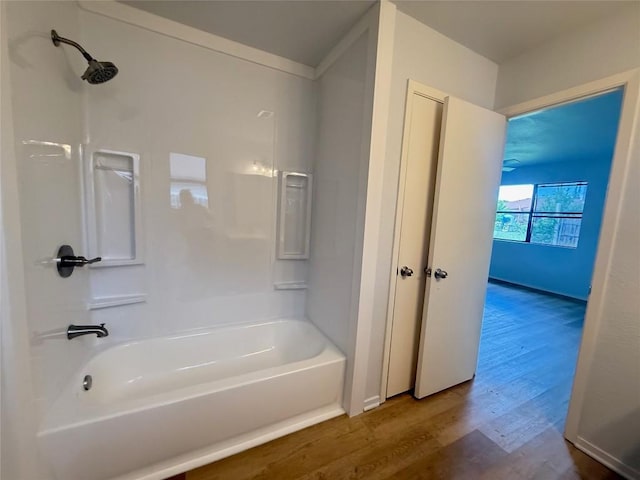 full bath with wood finished floors and shower / washtub combination