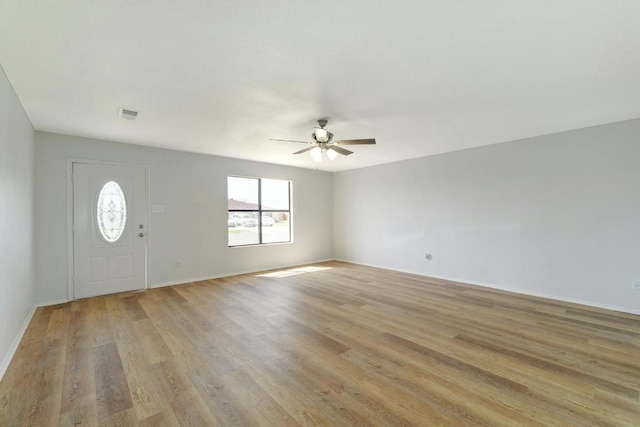 foyer entrance featuring ceiling fan, light wood-type flooring, and baseboards