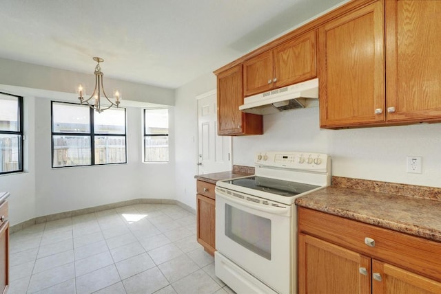 kitchen featuring electric range, under cabinet range hood, healthy amount of natural light, and brown cabinetry