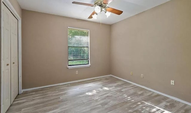 1919 Castle Gate Cir, San Marcos, TX 78666 - unfurnished bedroom with wood finished floors, a closet, and ceiling fan