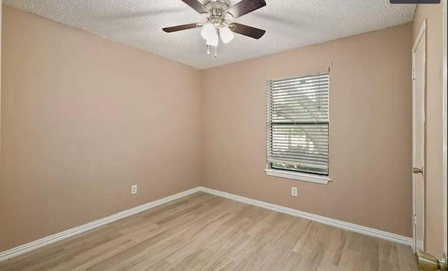 1919 Castle Gate Cir, San Marcos, TX 78666 - spare room with light wood finished floors, a textured ceiling, baseboards, and ceiling fan