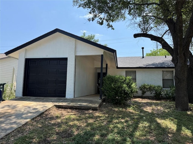 1919 Castle Gate Cir, San Marcos, TX 78666 - view of front of home with brick siding, a front lawn, concrete driveway, and a garage