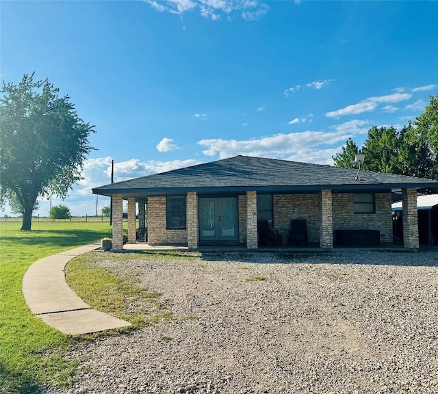 2355 County Road 130, Hutto, TX 78634 - view of front of house featuring french doors, a front lawn, and stone siding