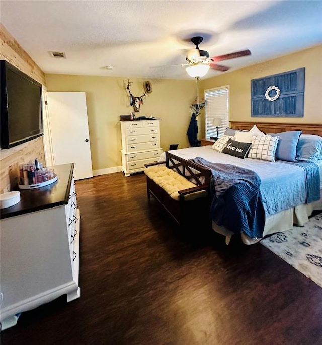 2355 County Road 130, Hutto, TX 78634 - bedroom with dark wood finished floors, ceiling fan, and baseboards