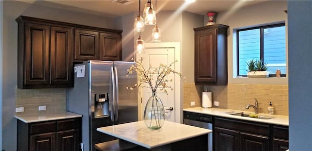 2020 Tripshaw Ln Unit 65C, Austin, TX 78741 - kitchen with stainless steel appliances, a sink, light countertops, tasteful backsplash, and dark brown cabinets