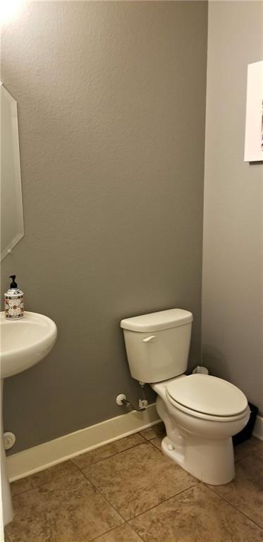2020 Tripshaw Ln Unit 65C, Austin, TX 78741 - bathroom featuring toilet, tile patterned flooring, and baseboards