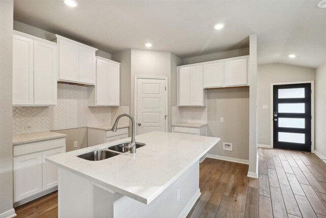 825 Sun Grove Trl, Georgetown, TX 78628 - kitchen with a sink, a center island with sink, dark wood-style floors, white cabinets, and recessed lighting