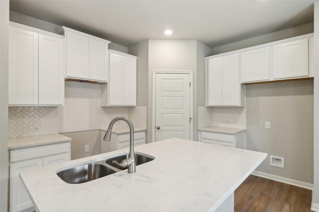 825 Sun Grove Trl, Georgetown, TX 78628 - kitchen with a sink, dark wood-style floors, a center island with sink, recessed lighting, and baseboards