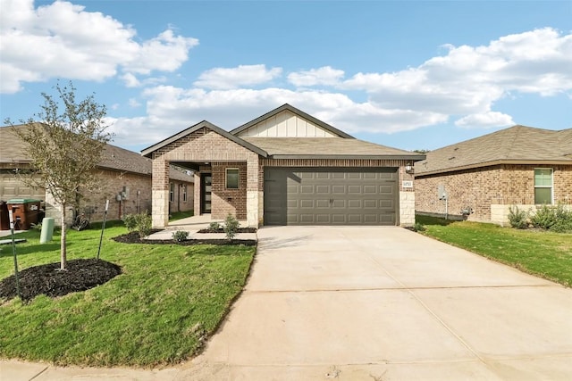 825 Sun Grove Trl, Georgetown, TX 78628 - view of front of home featuring brick siding, an attached garage, a front yard, driveway, and board and batten siding