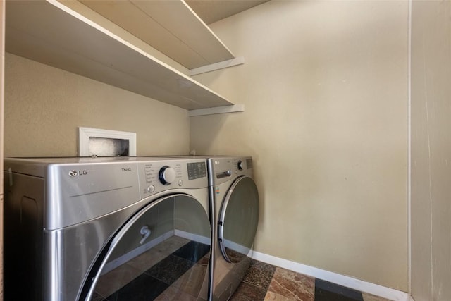 8500 Woodstone Dr, Austin, TX 78757 - washroom with washer and clothes dryer and baseboards