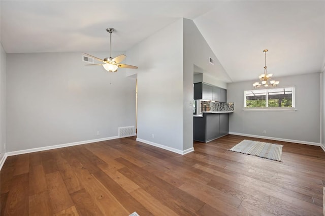 8500 Woodstone Dr, Austin, TX 78757 - unfurnished living room featuring vaulted ceiling, a chandelier, dark wood-style floors, and ceiling fan